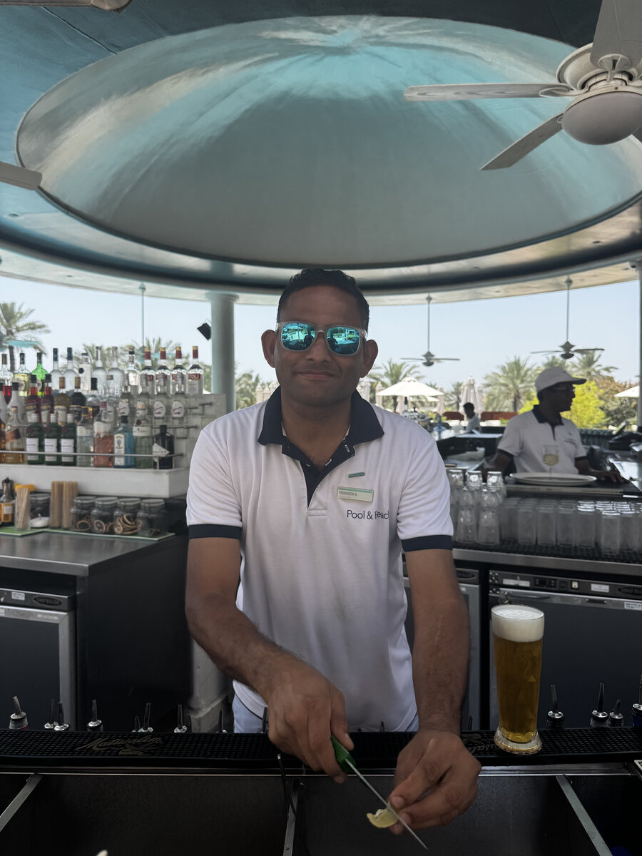 Praveen, smiling behind aviator sunglasses